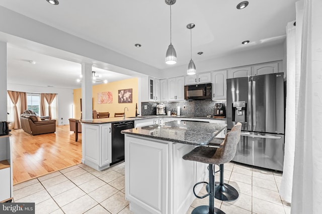 3436 Caledonia Cir, Woodbridge, VA 22192 - kitchen featuring black appliances, a peninsula, light tile patterned floors, tasteful backsplash, and a center island
