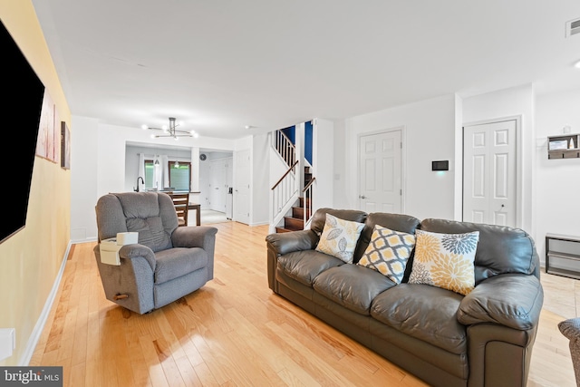 3436 Caledonia Cir, Woodbridge, VA 22192 - living area with stairs, light wood-type flooring, and a chandelier