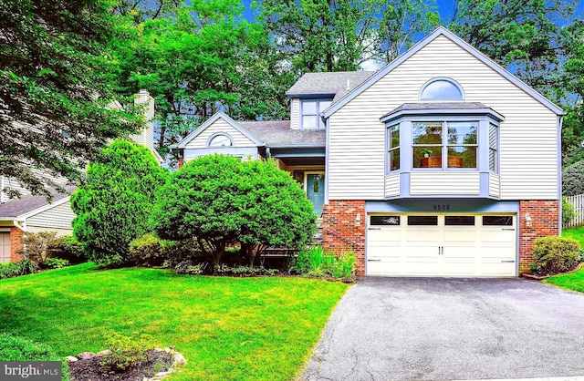 9505 Columbia Blvd, Silver Spring, MD 20910 - view of front of house with brick siding, driveway, a garage, and a front lawn