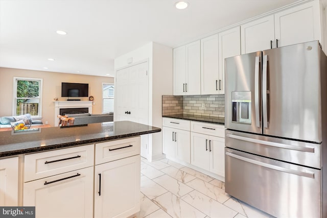 9505 Columbia Blvd, Silver Spring, MD 20910 - kitchen featuring stainless steel fridge, light marble finish floors, a fireplace, white cabinets, and dark stone countertops