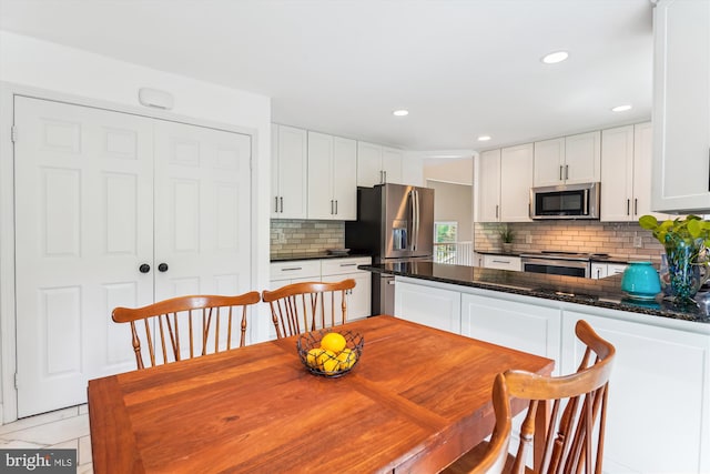 9505 Columbia Blvd, Silver Spring, MD 20910 - kitchen with appliances with stainless steel finishes, tasteful backsplash, white cabinets, a peninsula, and recessed lighting