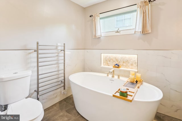 9505 Columbia Blvd, Silver Spring, MD 20910 - full bathroom with tile walls, a freestanding bath, a wainscoted wall, and a towel warming rack