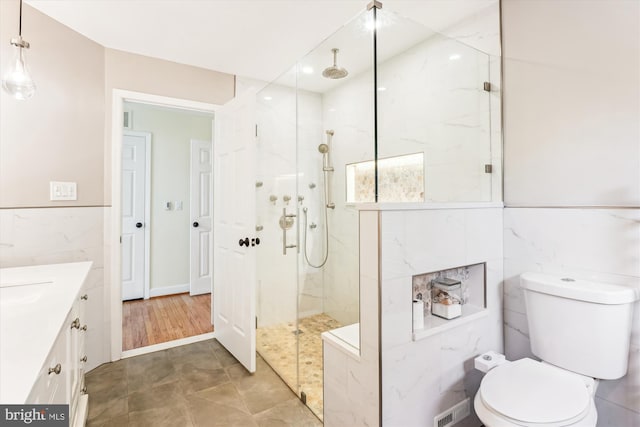 9505 Columbia Blvd, Silver Spring, MD 20910 - bathroom featuring a marble finish shower, vanity, and tile walls