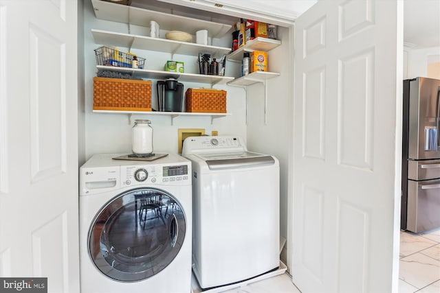 9505 Columbia Blvd, Silver Spring, MD 20910 - washroom with washer and clothes dryer and light marble finish floors