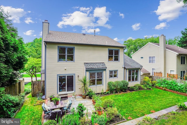 9505 Columbia Blvd, Silver Spring, MD 20910 - back of house featuring a fenced backyard, a patio, a shingled roof, and a chimney