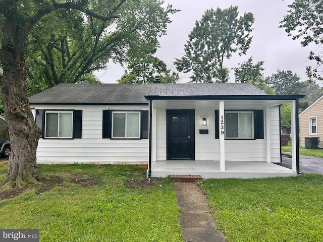 1239 Guildford Rd, Glen Burnie, MD 21060 - ranch-style house featuring covered porch, a front yard, and a shingled roof