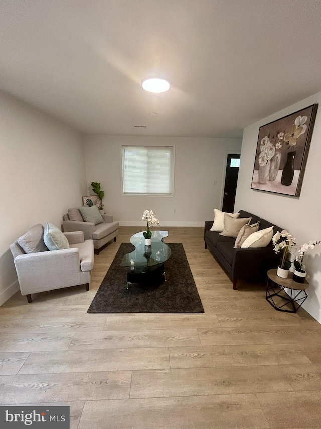 1239 Guildford Rd, Glen Burnie, MD 21060 - living area featuring light wood-type flooring and baseboards