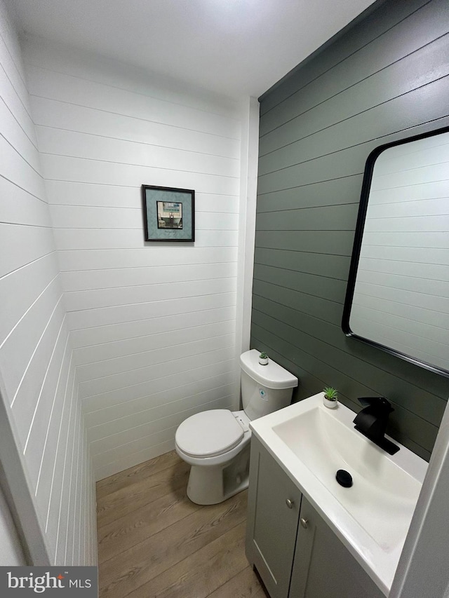 1239 Guildford Rd, Glen Burnie, MD 21060 - half bath featuring wood finished floors, vanity, and wood walls