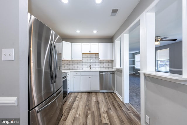 1537 Havilland Pl, Frederick, MD 21702 - kitchen with stainless steel appliances, white cabinetry, recessed lighting, wood finished floors, and light countertops