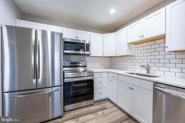 1537 Havilland Pl, Frederick, MD 21702 - kitchen with stainless steel appliances, light countertops, white cabinetry, recessed lighting, and light wood-style flooring