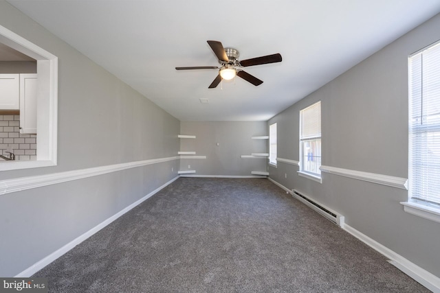 1537 Havilland Pl, Frederick, MD 21702 - unfurnished room with a baseboard heating unit, a ceiling fan, healthy amount of natural light, and dark carpet