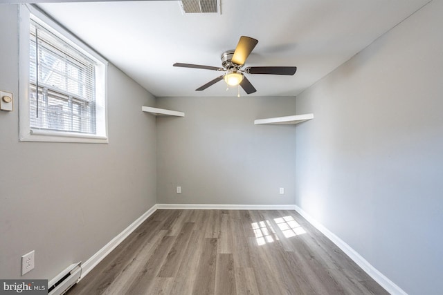 1537 Havilland Pl, Frederick, MD 21702 - spare room featuring a baseboard radiator, wood finished floors, and ceiling fan