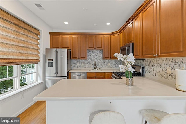 121 Kyle Way, Ewing, NJ 08628 - kitchen featuring stainless steel appliances, a peninsula, light countertops, tasteful backsplash, and recessed lighting