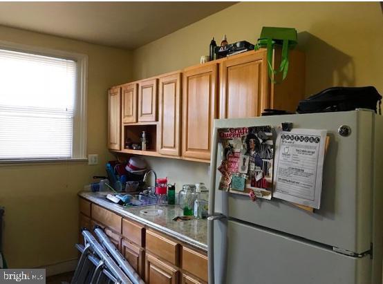 3231 Fontain St, Philadelphia, PA 19121 - kitchen featuring freestanding refrigerator and open shelves