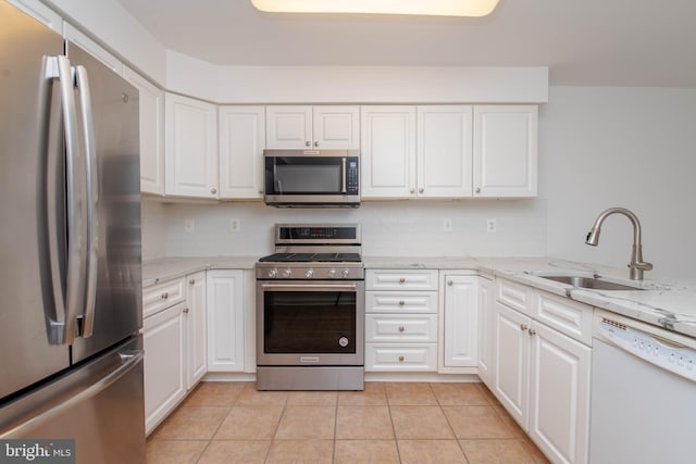 12030 Tralee Rd Unit 306, Lutherville Timonium, MD 21093 - kitchen featuring appliances with stainless steel finishes, backsplash, white cabinets, and light tile patterned floors