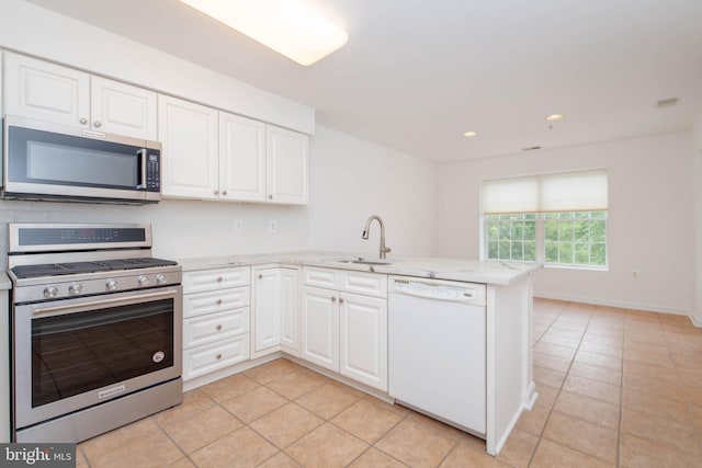 12030 Tralee Rd Unit 306, Lutherville Timonium, MD 21093 - kitchen featuring appliances with stainless steel finishes, a peninsula, light tile patterned floors, white cabinetry, and recessed lighting