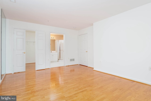 12030 Tralee Rd Unit 306, Lutherville Timonium, MD 21093 - unfurnished bedroom with light wood finished floors, ensuite bath, a closet, and a spacious closet
