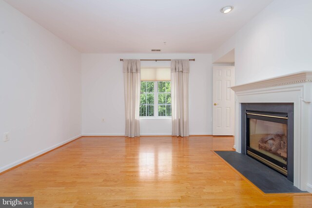 12030 Tralee Rd Unit 306, Lutherville Timonium, MD 21093 - unfurnished living room with wood finished floors and a fireplace with flush hearth