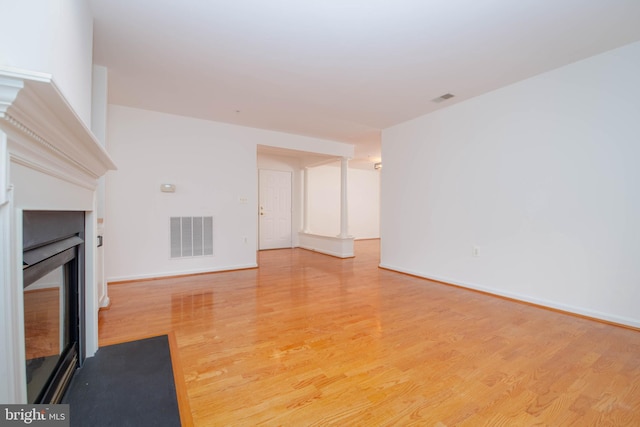 12030 Tralee Rd Unit 306, Lutherville Timonium, MD 21093 - unfurnished living room featuring a fireplace and light wood-style flooring