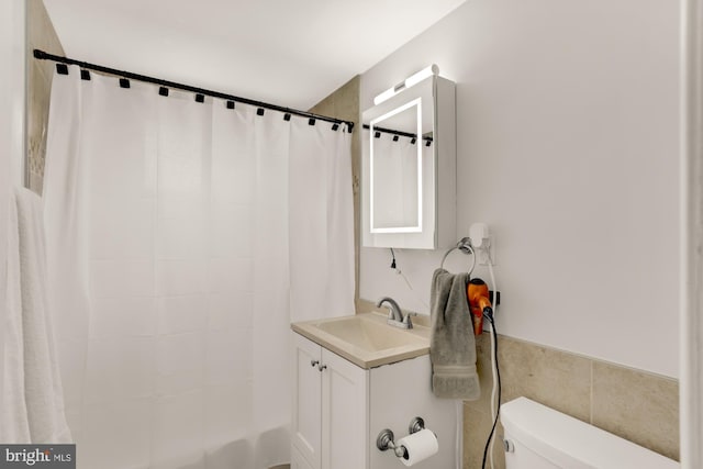 1200 S Arlington Ridge Rd Unit 507, Arlington, VA 22202 - bathroom with vanity, tile walls, shower / tub combo with curtain, and wainscoting