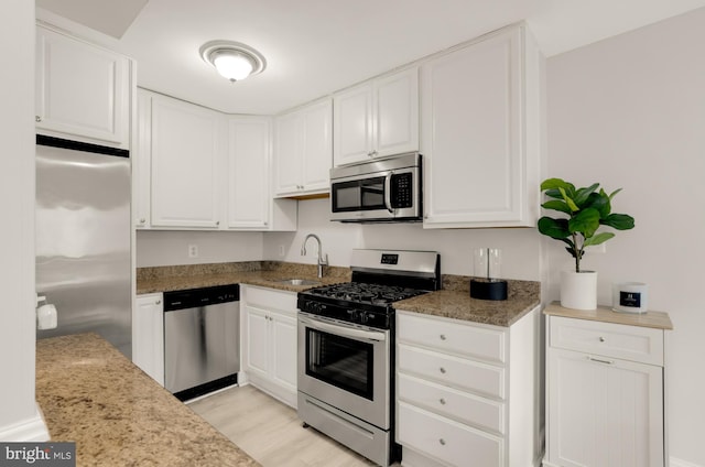 1200 S Arlington Ridge Rd Unit 507, Arlington, VA 22202 - kitchen with stainless steel appliances, white cabinets, light wood finished floors, and stone counters