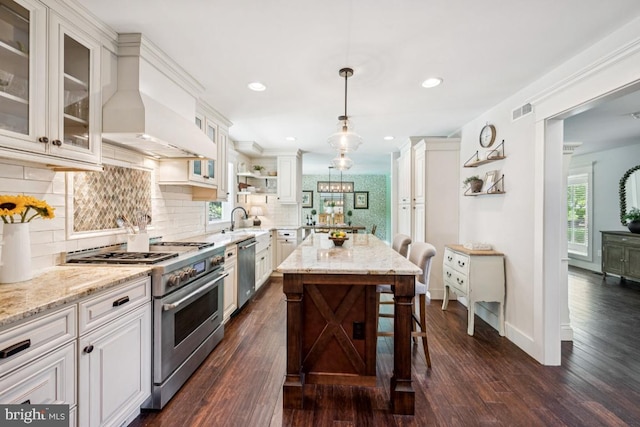 236 Carriage Hill Dr, Moorestown, NJ 08057 - kitchen featuring stainless steel appliances, dark wood finished floors, tasteful backsplash, a kitchen breakfast bar, and light stone counters