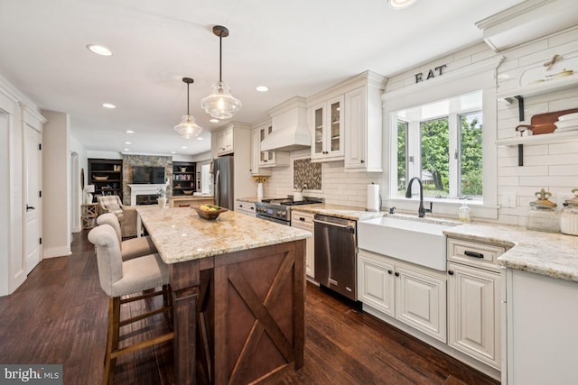 236 Carriage Hill Dr, Moorestown, NJ 08057 - kitchen with appliances with stainless steel finishes, premium range hood, light stone countertops, tasteful backsplash, and open floor plan