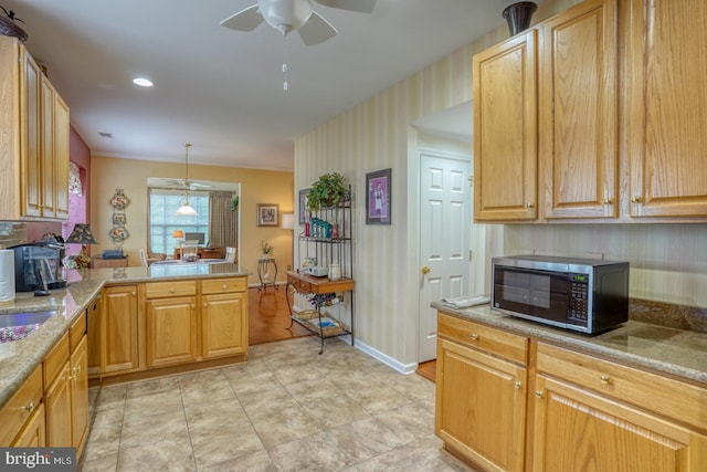 577 Whispering Trl, Middletown, DE 19709 - kitchen featuring black microwave, ceiling fan, light stone countertops, wallpapered walls, and pendant lighting