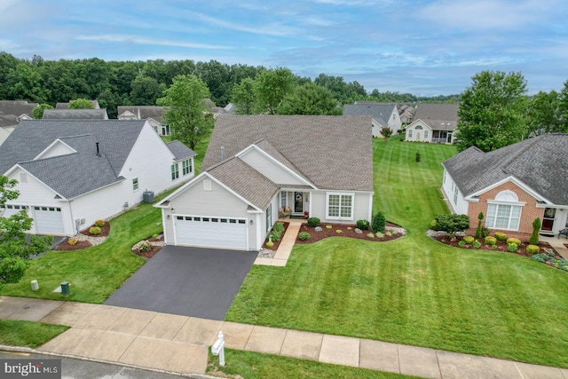 577 Whispering Trl, Middletown, DE 19709 - traditional-style home with a garage, asphalt driveway, a front yard, and a residential view