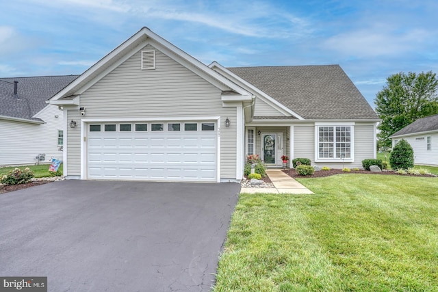 577 Whispering Trl, Middletown, DE 19709 - view of front of property featuring asphalt driveway, a garage, a front lawn, and a shingled roof