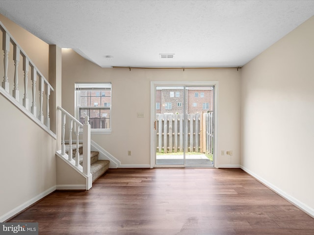 2635 Limestone Ct, Winchester, VA 22601 - foyer entrance featuring wood finished floors, stairway, and a textured ceiling