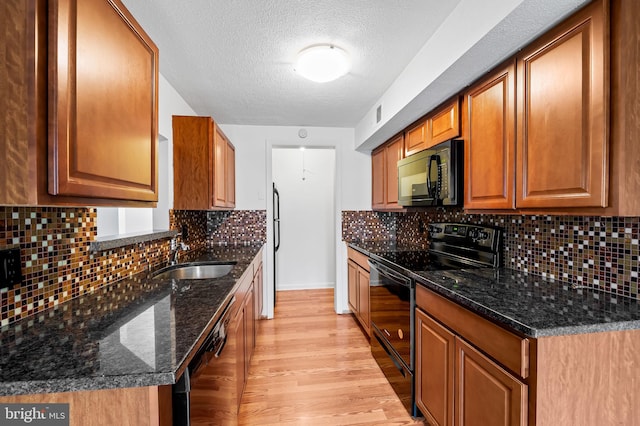 2 Brookshire Dr Unit A, Reisterstown, MD 21136 - kitchen featuring black appliances, a textured ceiling, light wood-style floors, brown cabinets, and decorative backsplash