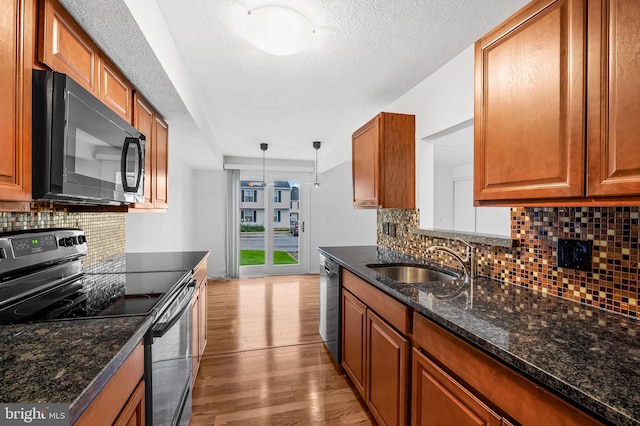 2 Brookshire Dr Unit A, Reisterstown, MD 21136 - kitchen with range with electric stovetop, black microwave, dishwashing machine, brown cabinets, and light wood finished floors