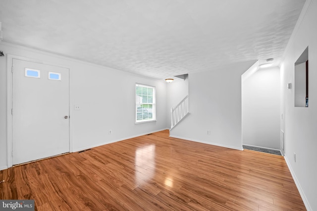 2 Brookshire Dr Unit A, Reisterstown, MD 21136 - unfurnished living room featuring wood finished floors and stairway