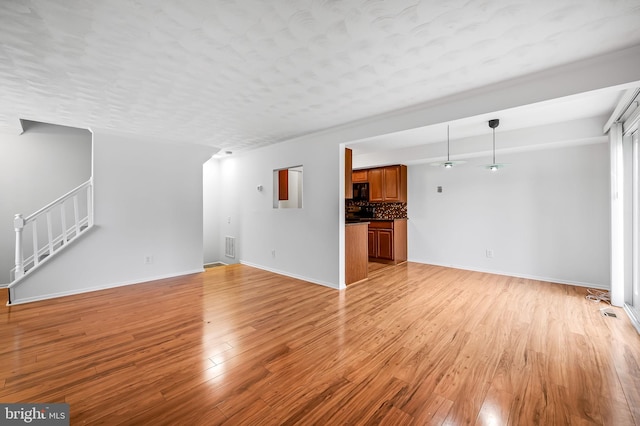 2 Brookshire Dr Unit A, Reisterstown, MD 21136 - unfurnished living room featuring light wood-style flooring and stairway