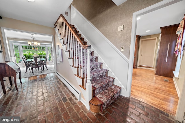 4105 Meadow Ln, Newtown Square, PA 19073 - staircase featuring a baseboard radiator, a chandelier, brick floors, and recessed lighting