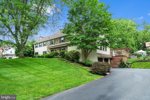 4105 Meadow Ln, Newtown Square, PA 19073 - view of front of home featuring driveway, a front lawn, stucco siding, a chimney, and a deck