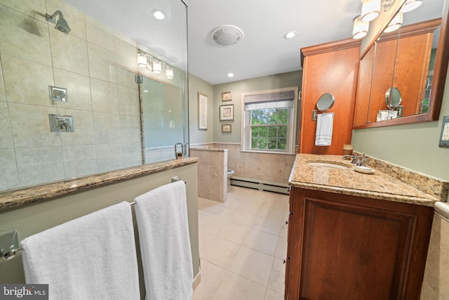 4105 Meadow Ln, Newtown Square, PA 19073 - bathroom with tile walls, a tile shower, baseboard heating, vanity, and tile patterned floors