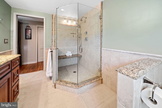4105 Meadow Ln, Newtown Square, PA 19073 - bathroom featuring a stall shower, a wainscoted wall, vanity, and tile patterned flooring