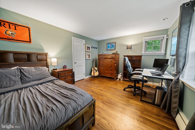 4105 Meadow Ln, Newtown Square, PA 19073 - bedroom with wood finished floors, a desk, and a baseboard radiator