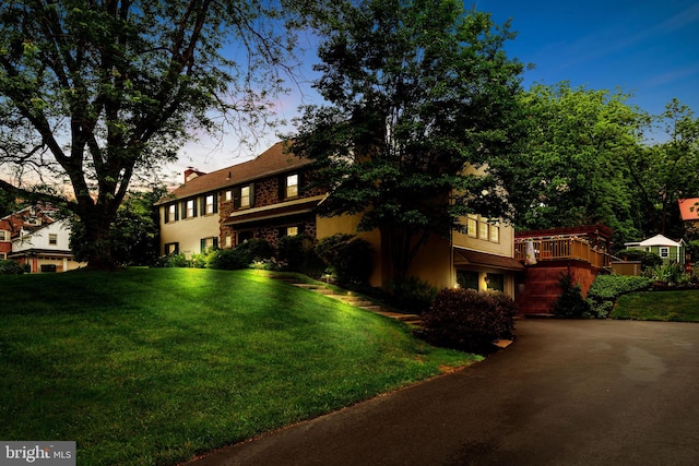 4105 Meadow Ln, Newtown Square, PA 19073 - view of front of property with driveway, a front yard, stucco siding, a chimney, and a deck