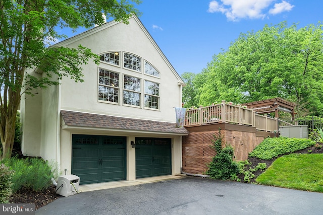 4105 Meadow Ln, Newtown Square, PA 19073 - view of home's exterior with stucco siding, driveway, an attached garage, and roof with shingles