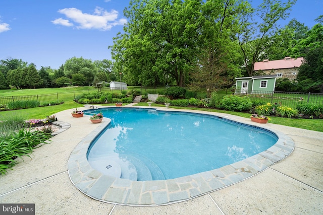 4105 Meadow Ln, Newtown Square, PA 19073 - view of swimming pool with view of wooded area, a patio area, and an outbuilding