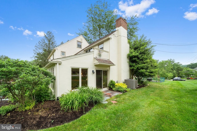 4105 Meadow Ln, Newtown Square, PA 19073 - view of front of home with a balcony, a front lawn, stucco siding, and a chimney