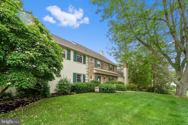 4105 Meadow Ln, Newtown Square, PA 19073 - rear view of house with a chimney, a lawn, stucco siding, and stone siding
