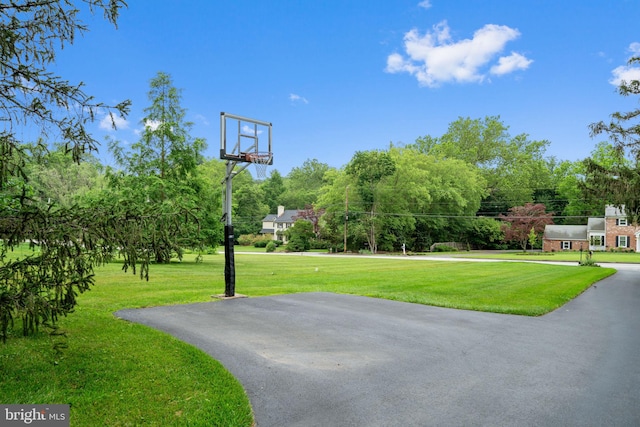 4105 Meadow Ln, Newtown Square, PA 19073 - view of basketball court with a lawn, basketball hoop, and view of wooded area