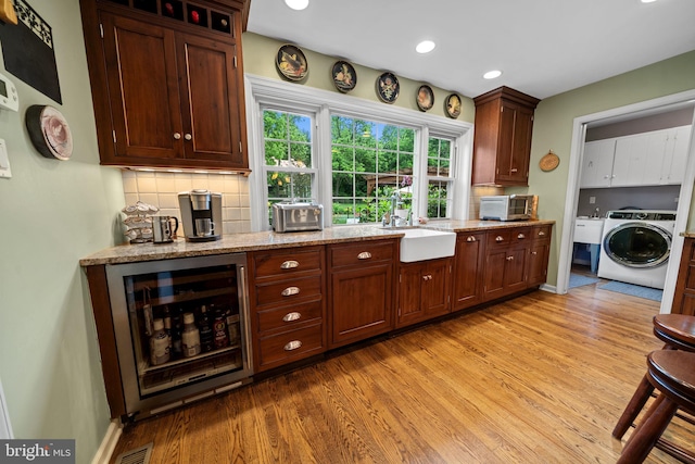 4105 Meadow Ln, Newtown Square, PA 19073 - kitchen featuring washer / dryer, wine cooler, light wood-style flooring, backsplash, and recessed lighting