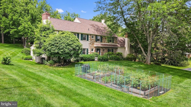 4105 Meadow Ln, Newtown Square, PA 19073 - back of property with a garden, a chimney, and a yard