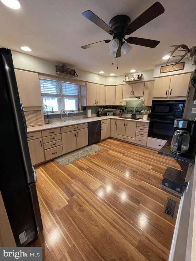 914 New Hope St, Norristown, PA 19401 - kitchen with black appliances, under cabinet range hood, a ceiling fan, light wood-type flooring, and light brown cabinetry