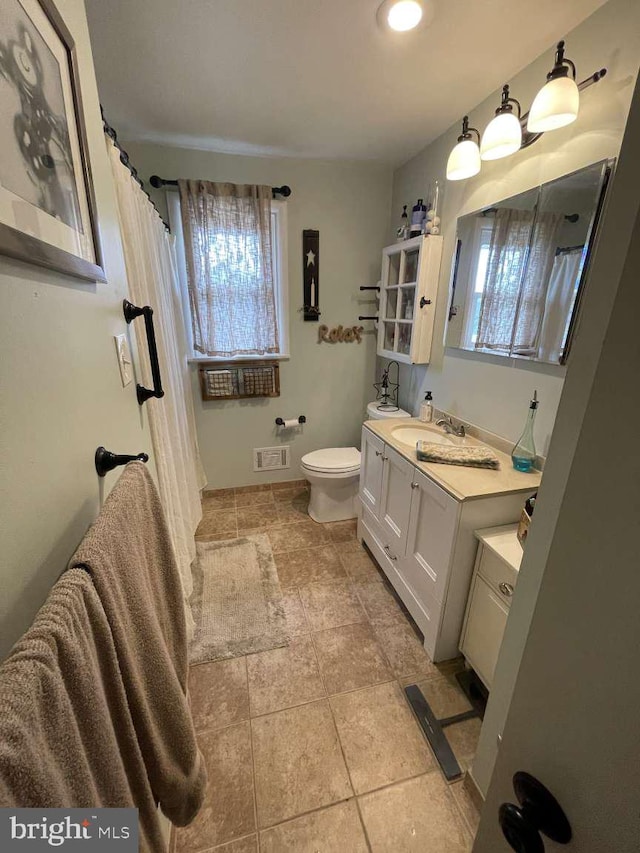 914 New Hope St, Norristown, PA 19401 - full bathroom with healthy amount of natural light, vanity, and stone finish floors
